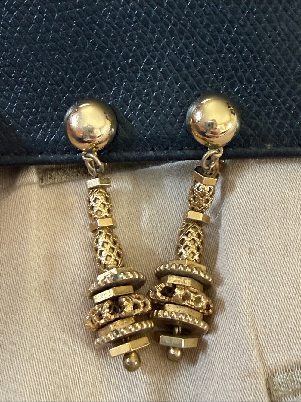 Vintage Monet gold-tone metal clip-on dangle earrings with tiered design